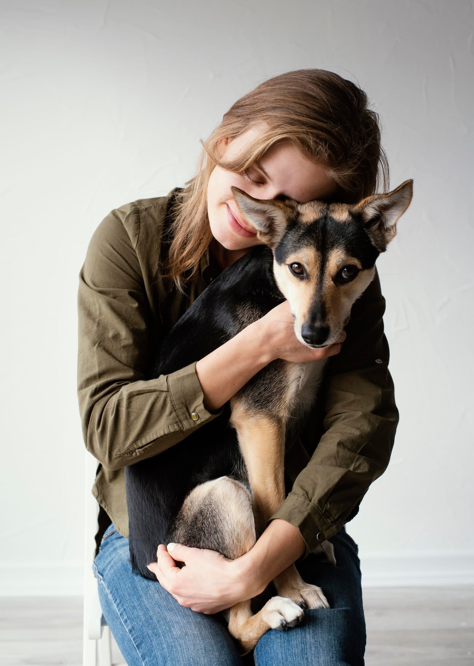 A volunteer gently holding an injured dog's paw